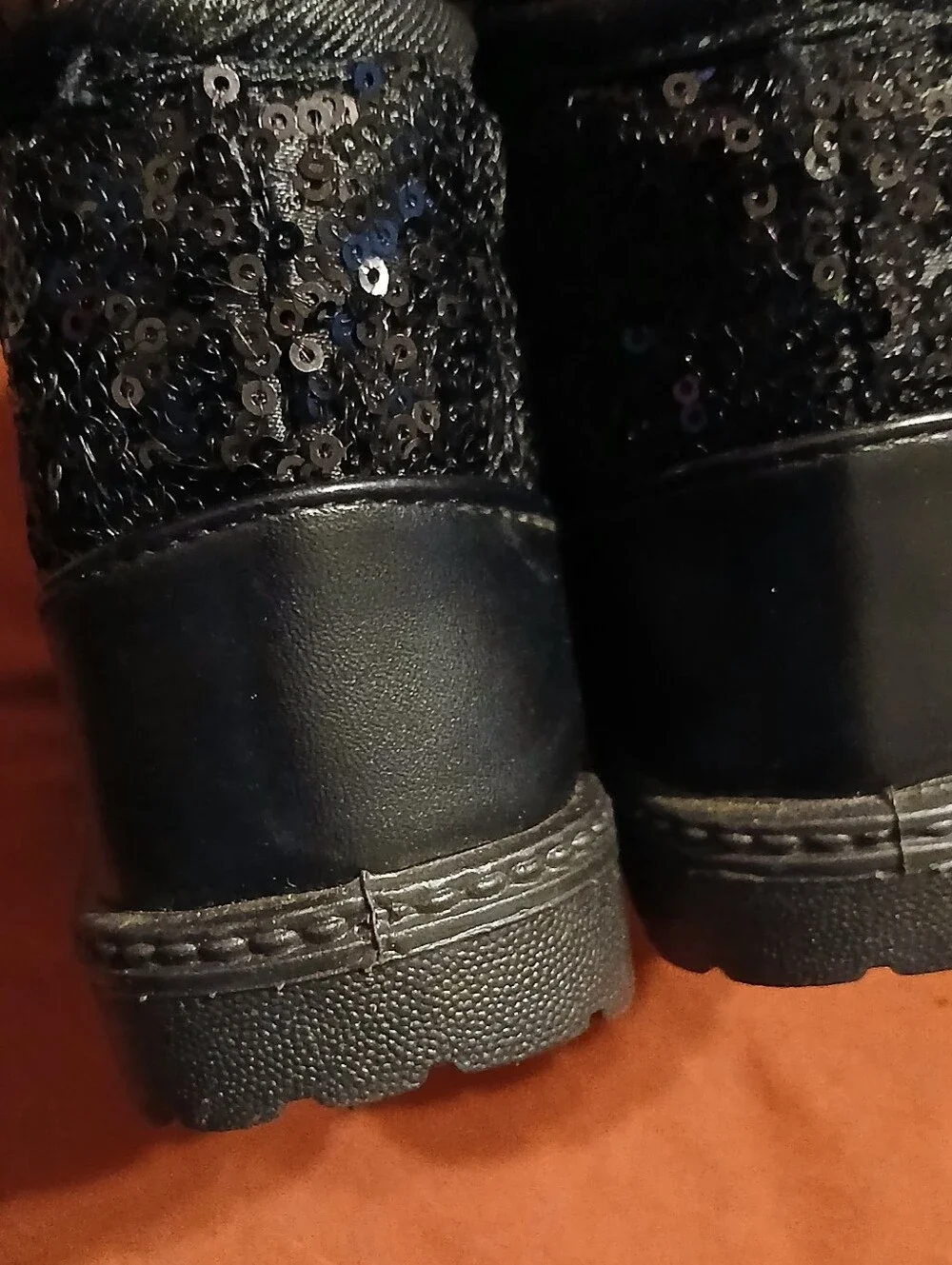 black sequin children's ankle boots with decorative bows and flat fur sole